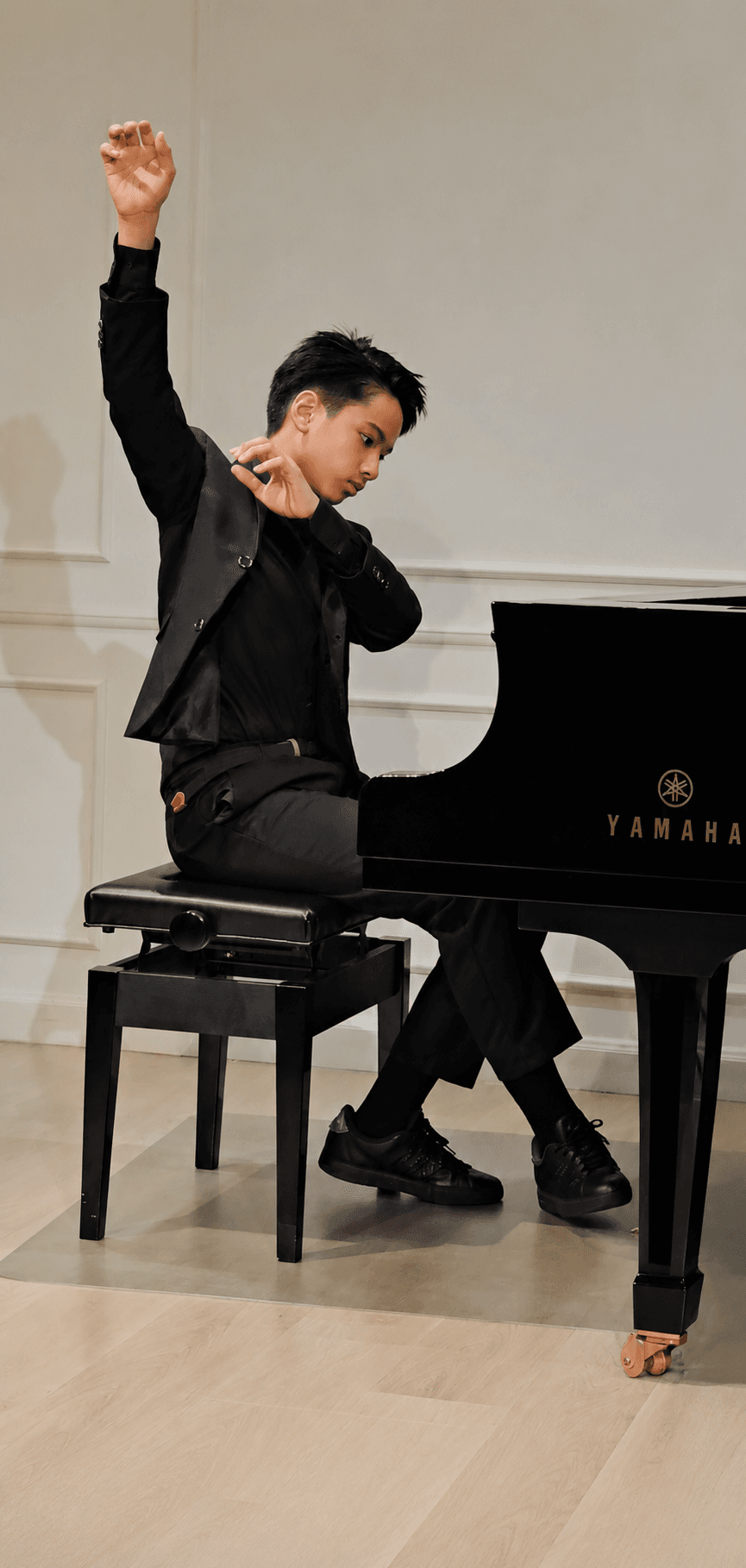 Matt.YC seated at a grand piano in a classical performance pose